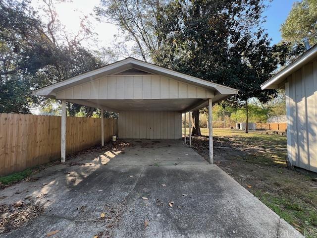 919 E Hamilton Ave, Wynne, AR 72396 - view of parking / parking lot featuring a detached carport, fence, and driveway