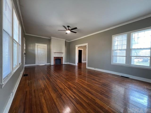 919 E Hamilton Ave, Wynne, AR 72396 - unfurnished living room featuring a ceiling fan, visible vents, a large fireplace, baseboards, and dark wood-type flooring