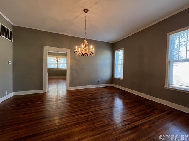 919 E Hamilton Ave, Wynne, AR 72396 - empty room with crown molding, a chandelier, and a wealth of natural light