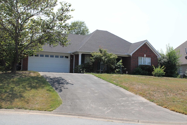 view of front facade featuring a front yard and a garage