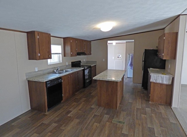 kitchen featuring a kitchen island, dark wood-type flooring, sink, black appliances, and vaulted ceiling