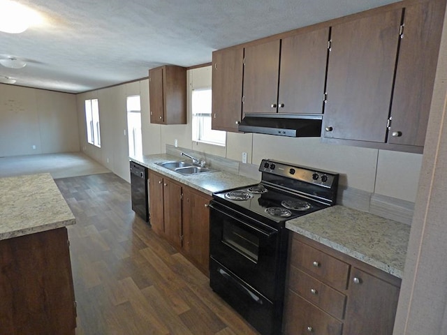 kitchen featuring black appliances, sink, a textured ceiling, range hood, and dark hardwood / wood-style floors