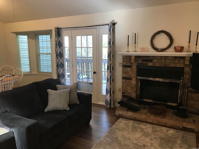 living room with dark hardwood / wood-style flooring and a fireplace