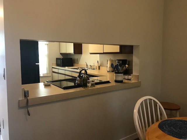 kitchen featuring sink and white cabinets