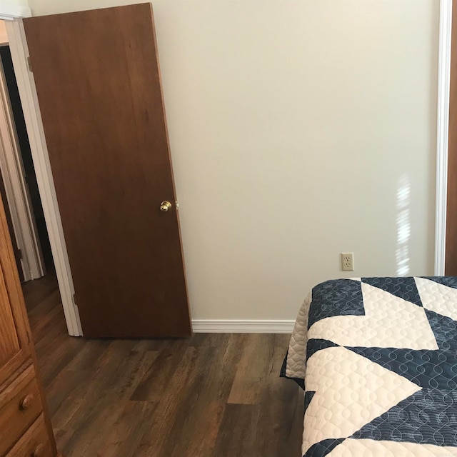 bedroom featuring dark wood-type flooring