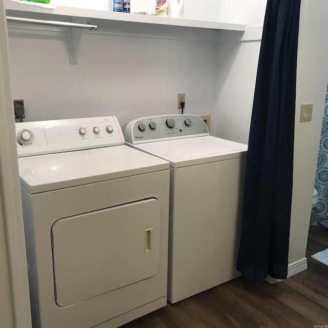 washroom with dark wood-type flooring and washer and clothes dryer