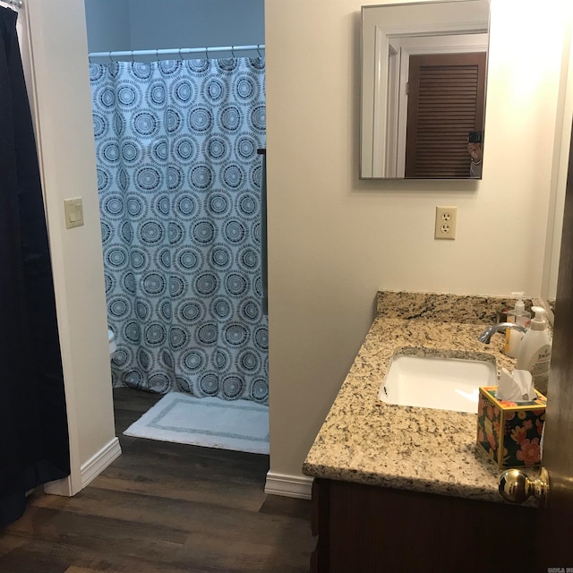 bathroom with vanity, wood-type flooring, and walk in shower