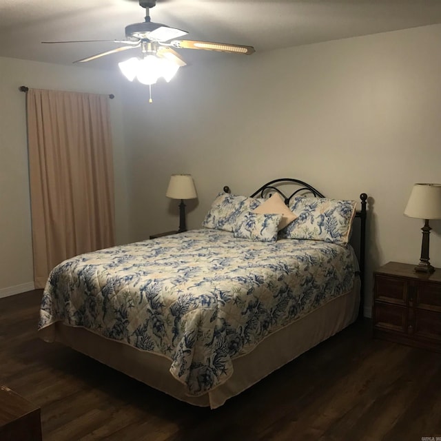 bedroom with ceiling fan and dark hardwood / wood-style flooring