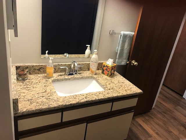 bathroom featuring vanity and hardwood / wood-style flooring