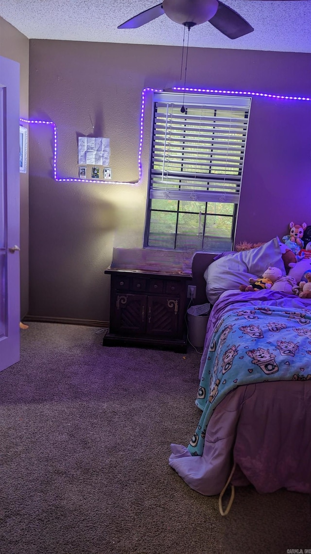 carpeted bedroom with a textured ceiling and ceiling fan