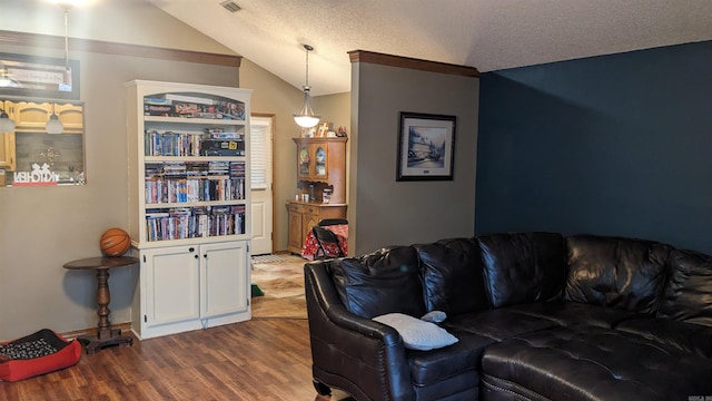 living room featuring light hardwood / wood-style flooring, crown molding, a textured ceiling, and vaulted ceiling