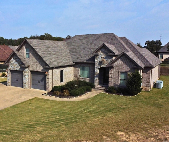 view of front facade featuring central air condition unit, a front lawn, and a garage