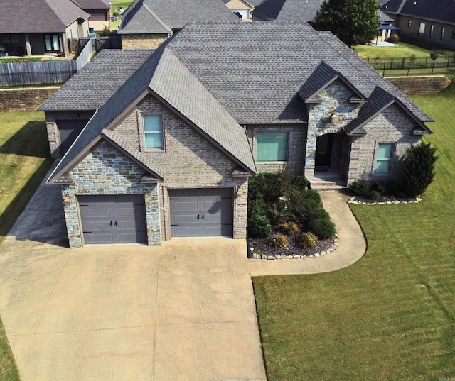 view of front of house with a front yard and a garage