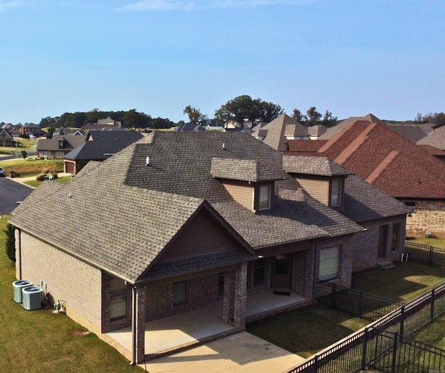 exterior space featuring a patio area, a yard, and cooling unit