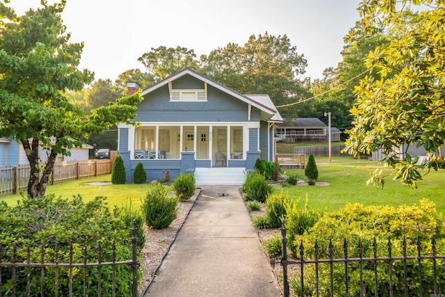 view of front of home with a porch and a front yard