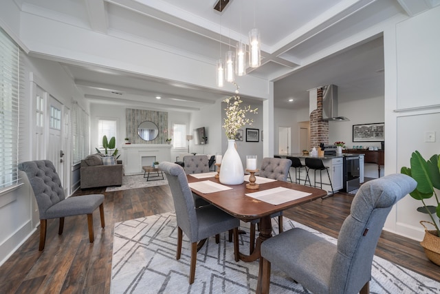 dining space featuring beam ceiling and wood-type flooring