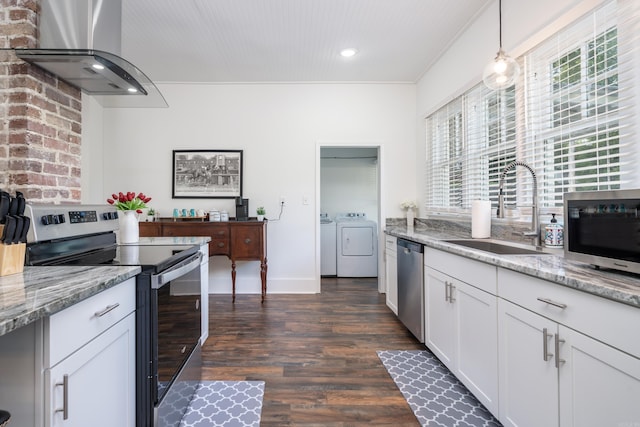 kitchen featuring appliances with stainless steel finishes, sink, separate washer and dryer, hanging light fixtures, and ventilation hood