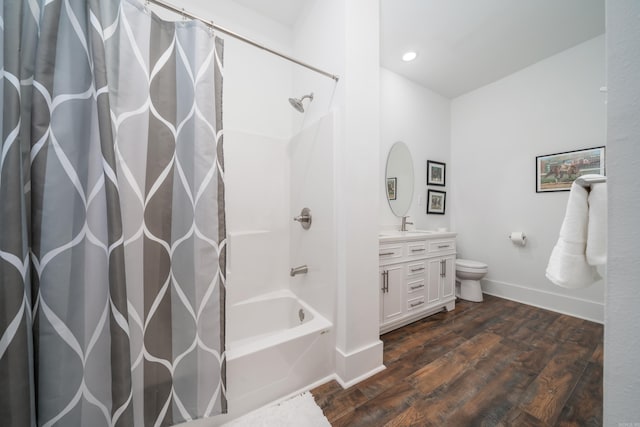 full bathroom featuring vanity, toilet, hardwood / wood-style flooring, and shower / tub combo with curtain