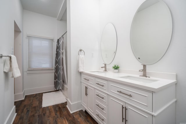 bathroom featuring vanity, hardwood / wood-style floors, and curtained shower