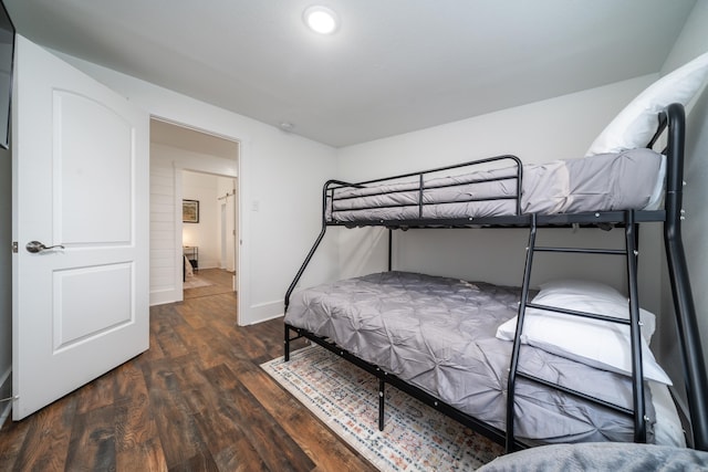 bedroom with dark hardwood / wood-style floors