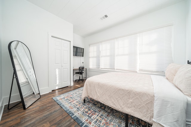 bedroom featuring a closet and dark hardwood / wood-style flooring