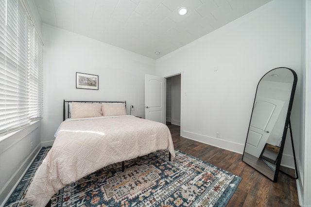 bedroom with dark wood-type flooring