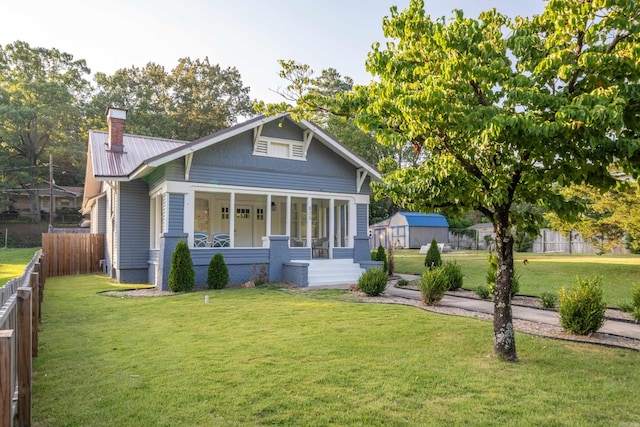 bungalow with a front yard and a porch