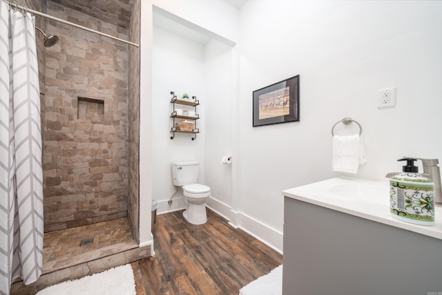 bathroom featuring toilet, hardwood / wood-style floors, vanity, and a shower with shower curtain