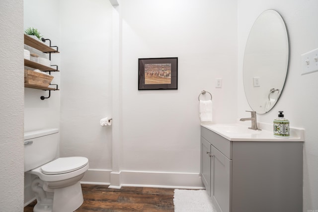 bathroom featuring vanity, toilet, and hardwood / wood-style flooring