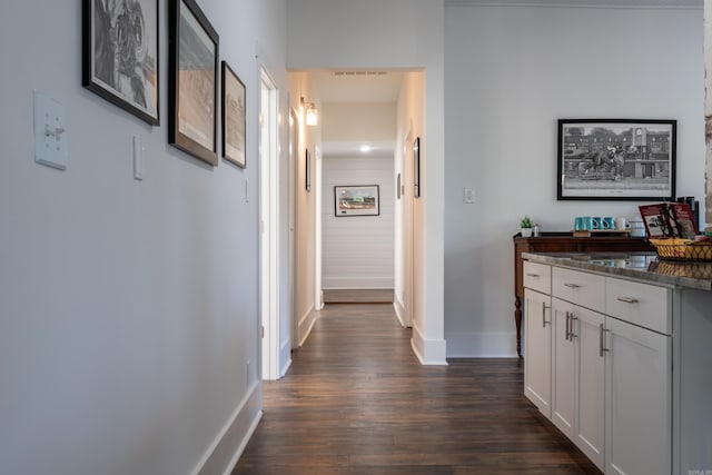 corridor with dark hardwood / wood-style floors