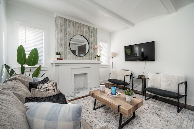 living room with crown molding, beamed ceiling, and a brick fireplace