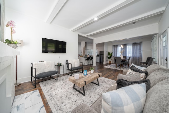 living room with beamed ceiling and hardwood / wood-style floors