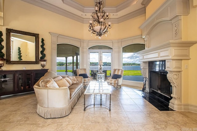 living room featuring ornamental molding, a high ceiling, and a chandelier