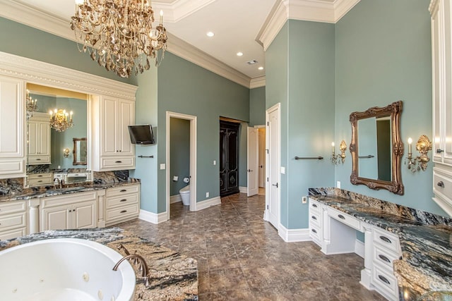 bathroom with toilet, a high ceiling, a bathing tub, vanity, and crown molding