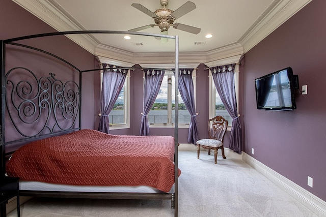 carpeted bedroom featuring multiple windows, ornamental molding, and ceiling fan