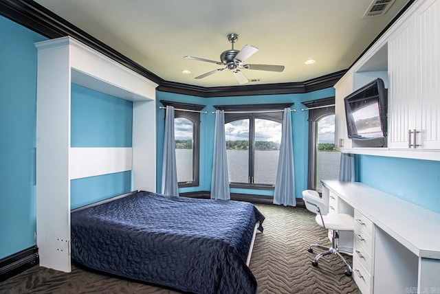 bedroom with ornamental molding, dark carpet, and ceiling fan