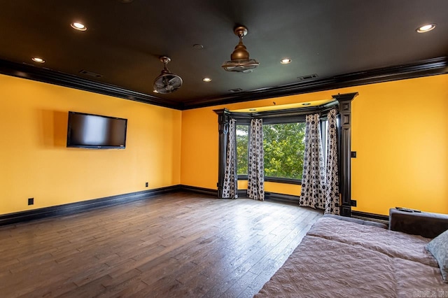 cinema with hardwood / wood-style floors and crown molding