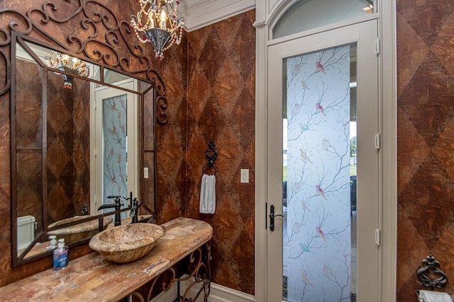 bathroom with vanity and ornamental molding