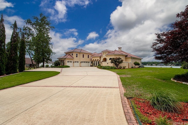 mediterranean / spanish house with a front yard and a garage