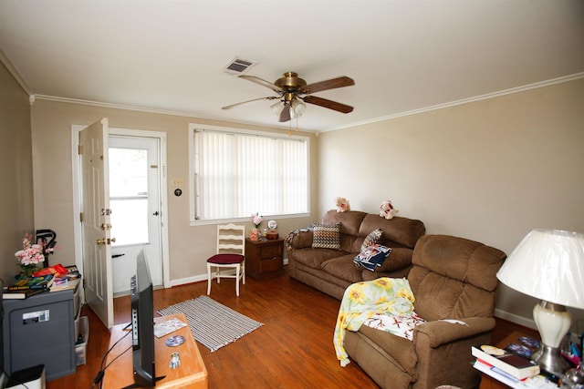 living room featuring dark hardwood / wood-style flooring, ceiling fan, and crown molding