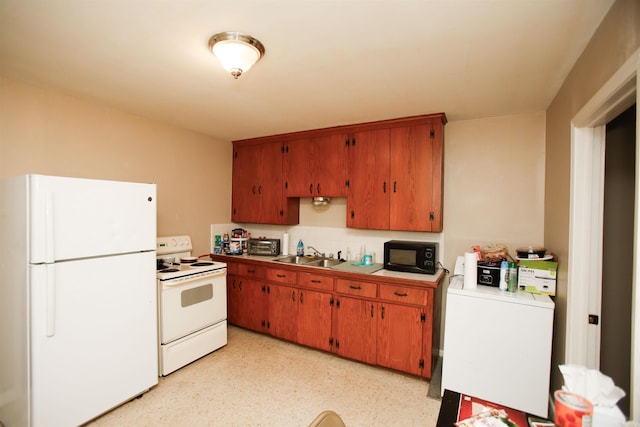 kitchen with white appliances, washer / dryer, and sink