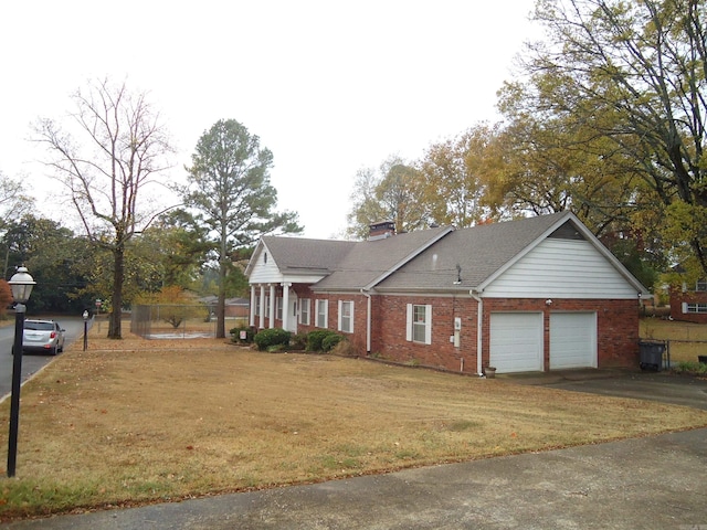 view of front facade with a garage and a front lawn