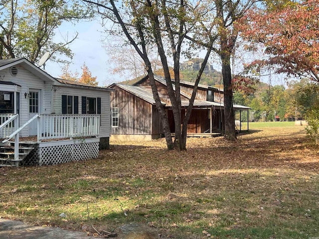 back of house with a yard and a mountain view