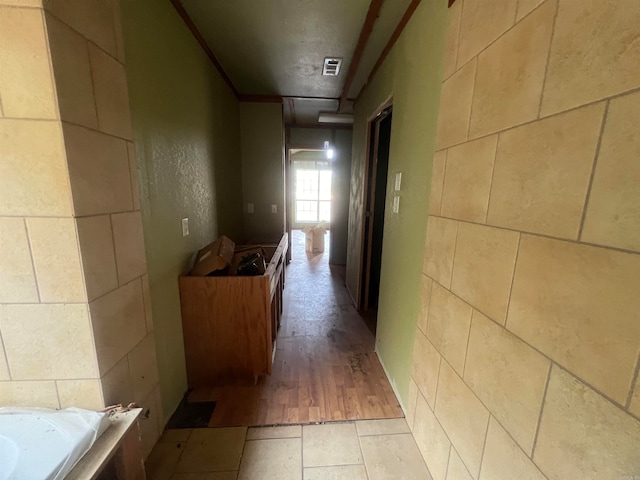 hallway with light hardwood / wood-style floors