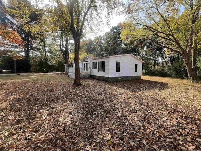 view of property exterior with a wooden deck