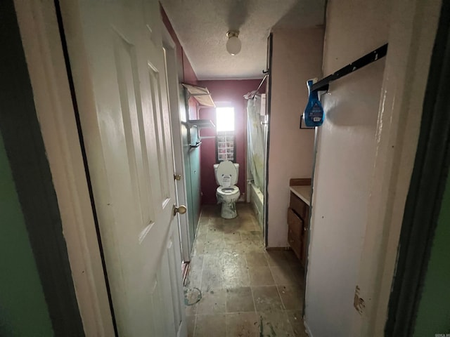 full bathroom with vanity, toilet, shower / bath combination with curtain, and a textured ceiling