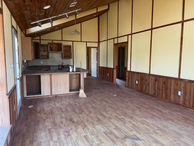 kitchen featuring track lighting, wood ceiling, wood-type flooring, high vaulted ceiling, and tasteful backsplash