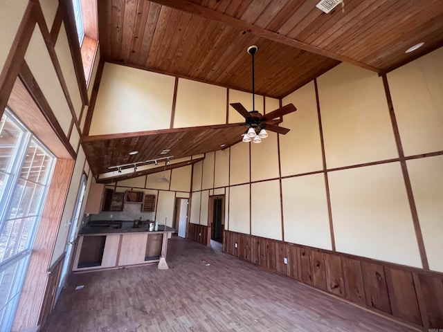 interior space featuring wood ceiling, lofted ceiling, and ceiling fan