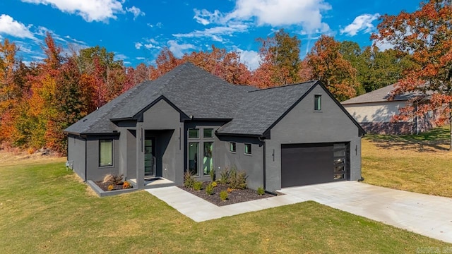 view of front of property featuring a front yard and a garage