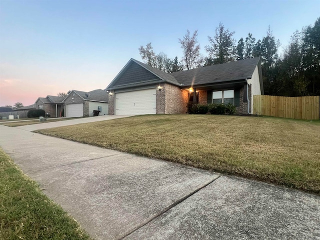 ranch-style house with a yard and a garage